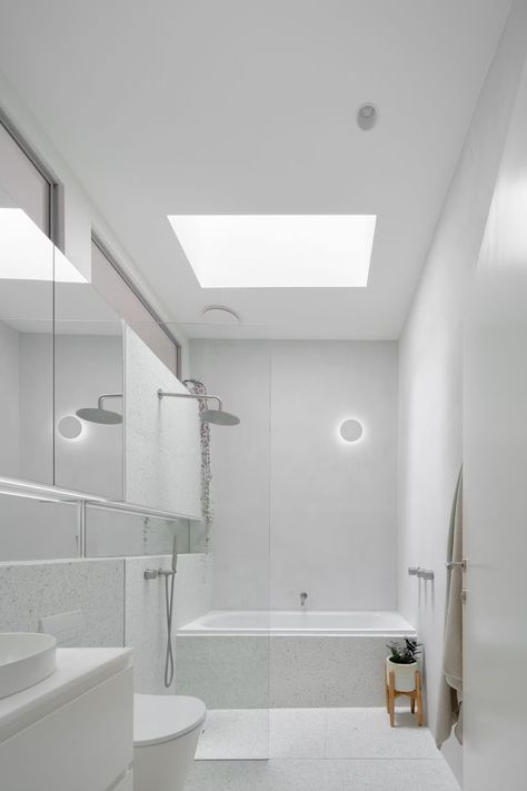 The cottage’s former bedroom is now the bathroom, and the team even managed to squeeze in a tub! A skylight with a sensor that responds to internal moisture levels floods the space with natural light, as well as two high windows that feed in light from the internal courtyard. Sydney Terrace, Skylight Bathroom, Stone Tile Wall, High Windows, Townhouse Designs, Sky Light, Internal Courtyard, A Sky, Inner City