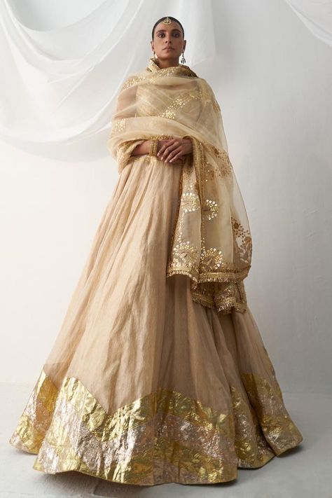 Beige attached cancan lehenga with zigzag lampi work. Comes with lampi gota sleeveless padded blouse and an organza gota patti embroidered dupatta. Components: 3 Pattern: Embroidered Type Of Work: Gota Neckline: U-Neck Sleeve Type: Sleeveless Fabric: Lampi Color: Beige Other Details:  Padded blouse Attached cancan lehenga Kiran lace dupatta Approx. product weight (in kgs): 6 Length: Blouse: 13 inches Lehenga: 44 inches Occasion: Wedding - Aza Fashions U Neck Blouse, Tissue Lehenga, Lace Dupatta, Cancan Lehenga, Chanya Choli, Blouse Lehenga, Gold Lehenga, Blouse Yoke, Navratri Chaniya Choli