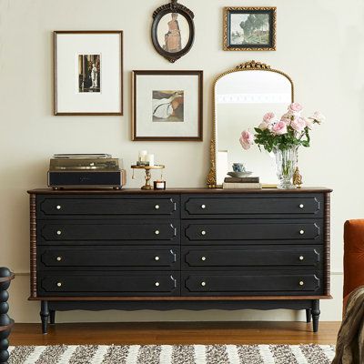 Embark on a journey of elegance and nostalgia with our French-style solid wood dresser. This eight-drawer cabinet is a testament to classic styling that never goes out of fashion. Boasting a sleek and retro design, it brings a touch of sophistication to any bedroom. Crafted from prized red oak wood, prized for its natural and straight grain, this dresser exudes a timeless elegance. The smoke black and walnut colour combination creates a retro collision of textures, exuding a high-end feel even i Black Antique Dresser Bedroom, Decor On Bedroom Dresser, Where To Place Dresser In Bedroom, Black Victorian Dresser, Bedroom Dresser Black, Refinished Vintage Dresser, Black Dresser Styling, Mirror On Dresser Leaning, Vintage Dresser Decor Ideas
