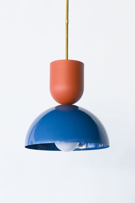 Large pendant light fixture for bathrooms, kitchens, and more. Features a color blocked dome in denim blue with a terra cotta extruded dome above it. Beautiful deep and colorful pendant light fixture. Mid Century Pendant Lighting Kitchen, Light Blue And Terracotta Bedroom, Colourful Pendant Lights, Mid Century Modern Pendant Light, Blue Light Fixture, Geometric Interior Design, Terracotta Bedroom, Geometric Interior, Red Pendant Light