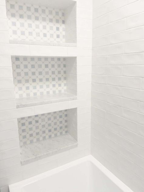 Choosing A Timeless White Subway Tile Bathroom | Hope And Hedges Shower Niche Tub Shower Combo, White Subway Tile Tub Shower Combo, Tub Shower Niche Ideas, White Subway Tile Tub Surround, White Subway Tile Bathroom Ideas, Marble Penny Tile Bathroom, White Tile Tub Surround, Bath To Shower Remodel, Vertical Subway Tile Bathroom