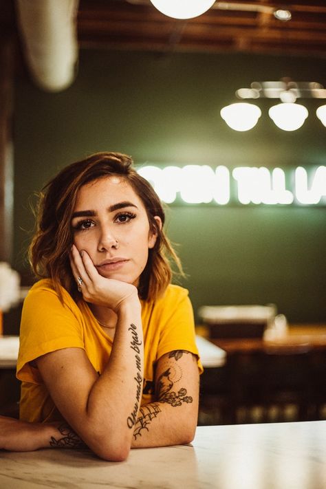 woman wearing yellow crew-neck shirt sitting beside table posing for photo Sitting On Table Pose Reference, Latest Background, Beside Table, Hd Wallpaper Iphone, Background Wallpapers, Sitting Poses, Pic Pose, Human Poses Reference, Instagram Ideas Photography