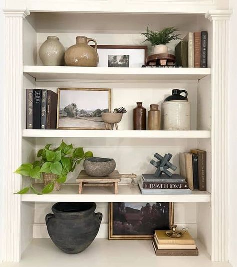 20 Transitional Shelf Styling Ideas » Lady Decluttered Picture Frame Styling Shelves, Vintage Vase Decorating Ideas, Top Of Built Ins Decor, Modern Vintage Shelf Decor, Earthy Bookshelf Decor, Book Case Styling Ideas, Office Shelf Decor Men, Shelf Decor Living Room Vintage, Open Shelf Styling Living Room