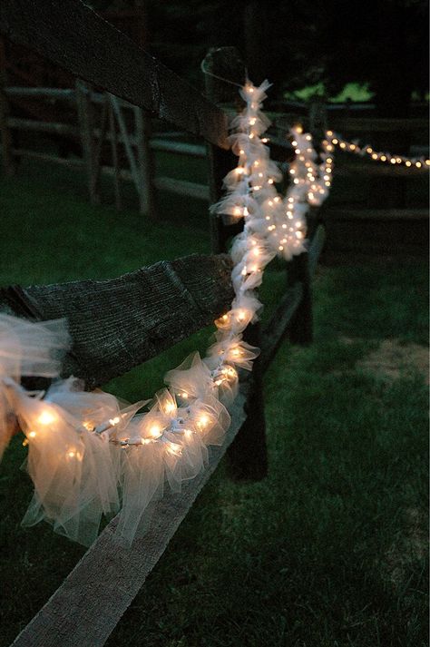 Tulle cut, tied inbetween each light and then hung around the fence Fence Party Decorating Ideas, Fence Decorating Ideas For Wedding, Fence Decorating Ideas For Party, Party Lights Diy, Light Goth, Tulle Wedding Decorations, Diy Wedding Lighting, Wedding Lighting Ideas, Tulle Lights