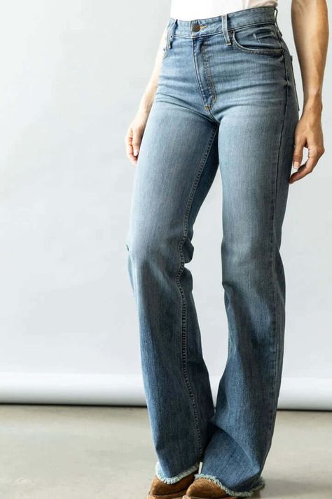 A high-rise stovepipe jean with a wide leg and raw hem, the Olivia is the perfect everyday jean. Made from our innovative tri-blend denim for maximum wearability and rebound, this lightweight jean is accented with our iconic Longhorn logo on both back pockets. Fabric: 82% Cotton | 15% Polyester | 3% Elastaine Fit: High Rise, Stove Top, Wide Leg with a Raw Hem Details: Hand sanding on light wash denim with whisker detail Construction: 11.5 Oz. Denim Our jeans have the longevity and durability you demand because we only source ring-spun denim. Ring-spun denim has greater tensile/tear strength in the fabric form than open-end yarn found in other brands. Thus our jeans last two to three times longer. Sizes: 000, 00, 0, 2, 4, 6, 8, 10, 12, 14, 16 Inseams: 30" 32" 34" 36" Fit Tip: ﻿Olivia is mos Ranch Boots For Women, Denim Ring, Italy Clothes, Kimes Ranch Jeans, Girl Cowboy Boots, Kimes Ranch, Lightweight Jeans, 9th Grade, Jane Seymour