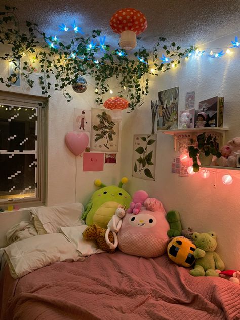 bed against corner of the room with vines hanging down with blue white and pink lights with plants and lanterns Fairy Dorm Room Aesthetic, Kawaii Cottagecore Room, Fairy Cottagecore Bedroom, Bedroom Inspirations Cottagecore, Maximalism Bedroom Aesthetic, Kawaii Cottagecore Bedroom, Simple Cottagecore Bedroom, Maximalism Cottagecore, Small Room Decor Ideas Aesthetic