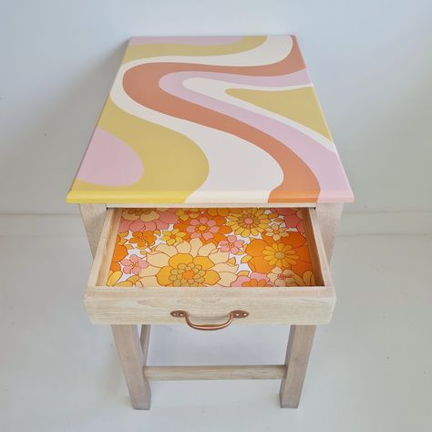 Painted desk with a flowing stripe desk design and an open drawer which has been lined with retro floral wallpaper. Colorful Side Table Diy, Painted Desk Ideas Fun, Funky Painted Side Table, 70s Inspired Painted Furniture, Aesthetic Table Painting, Funky Desk Ideas, Paint Drawers Ideas, Cute Diy Furniture, Fun Painted Table