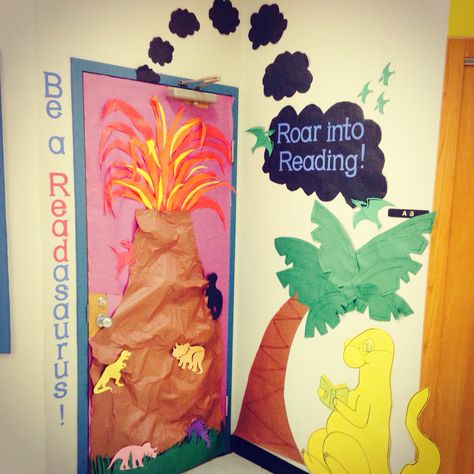 Dinosaur themed door for classroom Door For Classroom, Dinosaur Bulletin Boards, Dino Activities, Preschool Library, Dinosaur Classroom, Book Fairs, Dino Theme, Dinosaurs Preschool, Library Themes