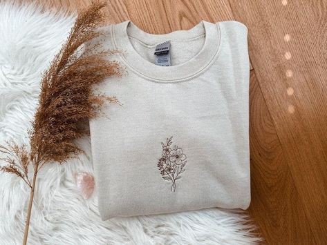 "Flower Bunch Embroidered Sweatshirt- Flower Embroidered Shirt- Flower Bun Crewneck Sweatshirt- Embroidered Shirt Gift For Mom Her Friend flower bunch, flower sweatshirt, flower shirt, embroidered shirt, embroidered tee, flower crewneck, gift for her, gift for mom, gift for wife, valentine gift, embroidered gift, unisex sweatshirt, embroidered HIGH TECH: This shirt with a design embroidered on a comfy cute crewneck. A sturdy and warm sweatshirt bound to keep you warm in the colder months. A pre- Cute Embroidered Crewneck, Embroidered Sweatshirt Flowers, Hoodie Embroidery Ideas, Hand Embroidered Hoodie, Diy Sweatshirts, Embroidered Flower Sweatshirt, Bunch Flower, Hoodie Embroidery, Sweatshirt Ideas