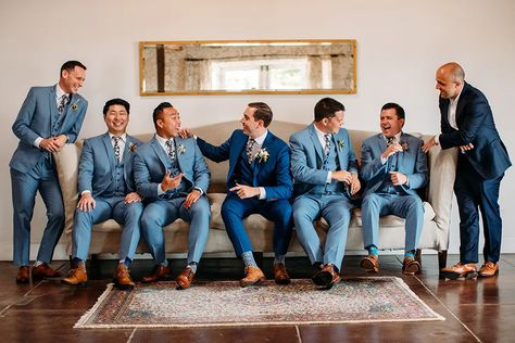 Blue Tux Bridal Party, Blue Suit Groomsmen And Bridesmaids, Heather Blue Suit Wedding, Blue Groom Beige Groomsmen, Summer Wedding Blue Suit, Navy And Copper Groomsmen, Blue And Tan Groomsmen Attire, Navy Blue And Peach Groomsmen Suits, Blue Suit Groomsmen Wedding