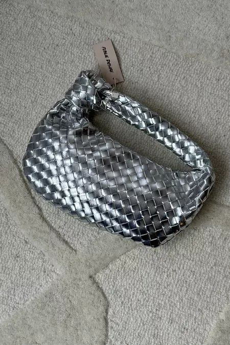 The most beautiful metallic bag to elevate any outfit. Bottega bag dupe | Designer dupes | Silver bag | Christmas Day outfit ideas | Trending bag | Metallic accessories | Statement | New Year’s Eve outfit #LTKparties #LTKitbag #LTKHoliday Silver Bottega Bag, Metallic Bag Outfit, Silver Bag Outfit, Bottega Bag Outfit, Bottega Bag, Pinterest Predicts, Metallic Accessories, New Year’s Eve Outfit, Christmas Day Outfit