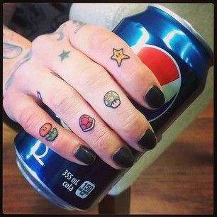 Super Mario Knuckle Tattoos | 30 Rad Tattoos Inspired By Nintendo  I wouldn't get them on my knuckles,but I would get a 1up shroom or the Star because their are the best Mario Tattoos, Super Mario Tattoo, Nintendo Tattoo, Mario Tattoo, Video Game Tattoos, Nerdy Tattoos, Gamer Tattoos, Nerd Tattoo, Knuckle Tattoos