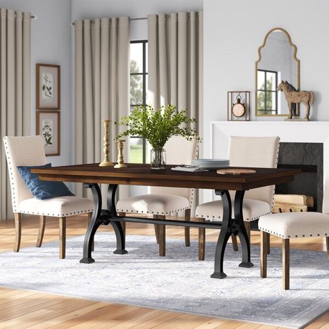 Fit for urban and industrial spaces, the clean lines and bold silhouettes of this dining table are sure to please. Its double pedestal base is crafted from cast iron and showcases a sinuous shape contrasted by the hard, clean lines of the tabletop, which is crafted from solid and manufactured wood. Measuring 74'' L x 42'' W x 30'' H, this design comfortably seats up to eight for casual family dinners and Sunday brunches alike. Classic Dining Table, Dining Table Black, Solid Wood Table, Solid Wood Dining Table, Table Wood, Leaf Table, Table Height, Extendable Dining Table, Kitchen Dining Furniture