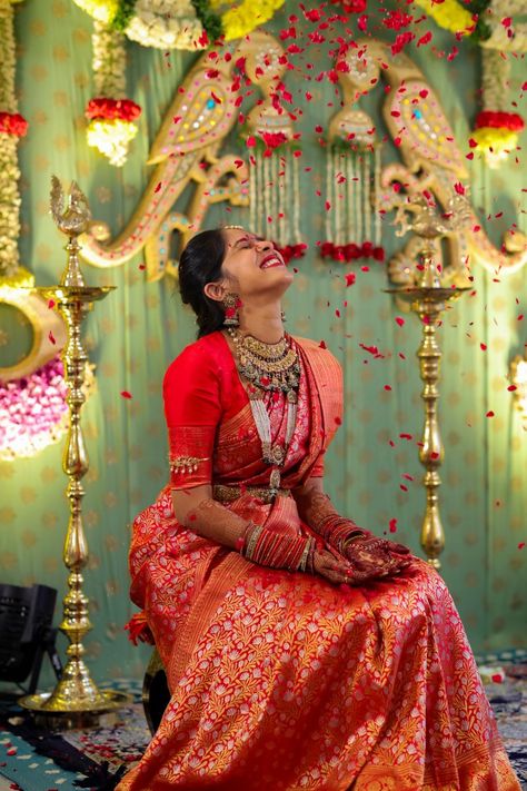 Photo of Bride playing with flower petals. Red Kanjeevaram Saree, Hyderabad Wedding, Saree Function, Photo Of Bride, Half Saree Function, Indian Bride Poses, Bridal Sarees South Indian, Indian Bridal Sarees, Wedding Lehenga Designs