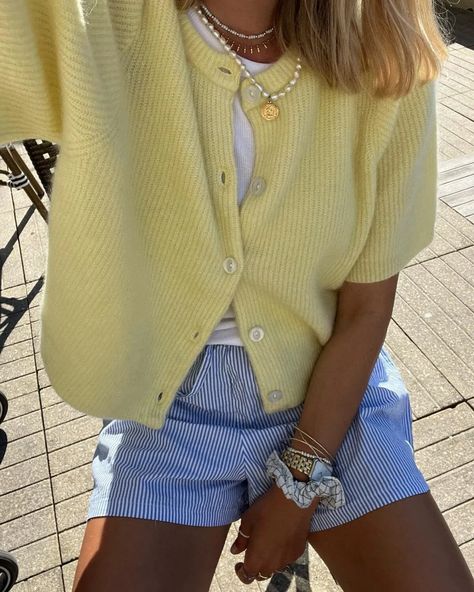 Butter yellow is the trendiest color to add to your spring and summer outfits this season, and we just love this casual outfit with a short pale yellow cardigan and blue striped shorts! Check out our article for more styling ideas and inspiration. Yellow Shorts Outfit, Shorts Outfits Women Summer, Yellow Cardigan Outfits, Blue Shorts Outfit, Striped Shorts Outfit, Yellow Skirt Outfits, Blue Summer Outfits, Neutral Summer Outfits, Blue Striped Shorts