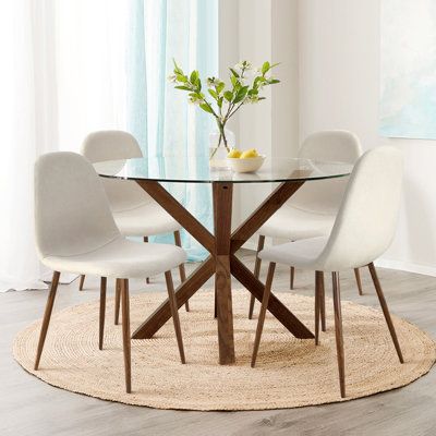 Give your dining room a fresh look with this dining set. The table is such a modern mid-century look. Clean, simple, timeless. The legs are crafted from steel in a warm walnut texture finish. The sculptural legs of this table are topped with transparent tempered glass, allowing the beauty of the construction to be exposed. With stylish oak-look metal legs and a fabric upholstered seat, you’ll be dining in style and comfort at every meal. | Corrigan Studio 5 Pieces Glass Round Dining Table Set Br Walnut Texture, Round Glass Dining Table, Glass Dining Table Set, Glass Dining Room Table, Round Dining Table Sets, Glass Round Dining Table, Walnut Dining Chair, Set The Table, Kitchen Dining Sets