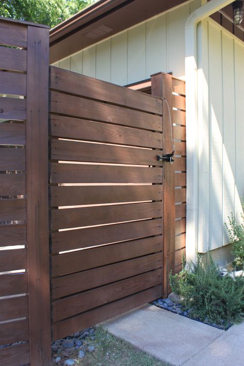 Beautiful color this russet, warm brown..slight redish tint. Semi-transparent stain/sealer with 25% colorant added…so it’s not too dark/not too light. Looks great. Slatted Gate Ideas, Fence With Double Gate, Vertical Fencing Ideas, Slat Gate, Slat Fencing, Yard Privacy, Gate Fence, Wood Fence Design, Wood Fences