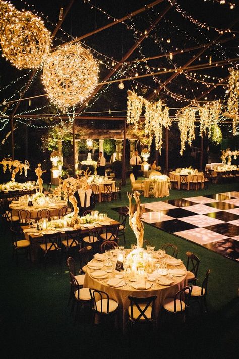 Create a modern day Great Gatsby wedding with this wedding venue inspiration. The decorative lights and checkered dance floor will have your guests in awe from the moment they walk inside. #greatgastbywedding #vintagewedding #weddingvenue #weddingtheme Indian Wedding Decorations Simple, Sangeet Aesthetic, Outdoor Night Wedding, Night Wedding Reception, Indian Wedding Decorations Receptions, Outdoor Wedding Lighting, Indian Wedding Ideas, Great Gatsby Wedding, Outdoor Fall Wedding