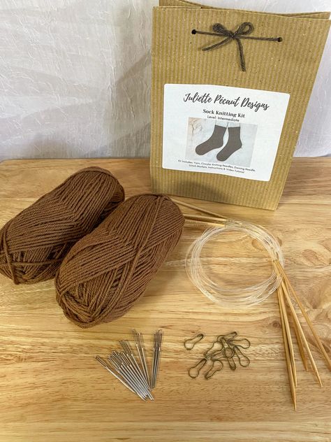 Learn how to knit toe-up, two-at-a-time socks confidently with this sock knitting kit! You’ll learn how to do a seamless cast on, knit two socks at once using magic loop, knit a short row heel, and a stretchy bind off to ensure your socks fit comfortably. The sport weight yarn is slightly thicker than the typical sock yarn, so these socks are quicker to knit and the 3.25mm needles are easier to learn the technique on. This wool makes for great, well-wearing everyday socks that you can wear with your favorite boots or casual shoes!Each kit contains:2 50g balls of 100% wool yarnCircular bamboo knitting needles1 darning needle3 stitch markers1 printed pattern with a link to a full video tutorial Each kit includes enough yarn to make 1 pair of adult socks. The video tutorial walks you through Short Row Heel, Stretchy Bind Off, Sock Knitting, Knitting Kit, Magic Loop, Learn How To Knit, Sport Weight Yarn, Favorite Boots, Bind Off