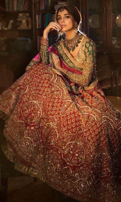 This lehenga is in raw silk in red color embellished with thread, beads, stones, fully hand-embroidered. Dupatta is in net fabric with two colours embroidered edges. Blouse of this lehenga is in raw silk while sleeves are embroidered on emerald green georgette fabric. Punjabi Wedding Dress, Green Bridal Lehenga, Lehenga Bridal, Indian Bridesmaids, Red Bridal Dress, Latest Bridal Lehenga, Sabyasachi Lehenga, Indian Bride Outfits, Wedding Dress Outfit