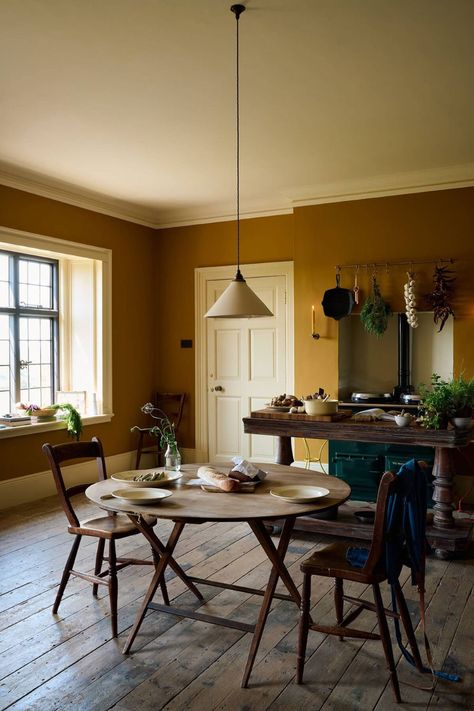 Kitchens by the English company deVOL are truly exquisite, blending traditional design with vibrant colors that breathe life into every space. This particular kitchen, located in a historic home with century-old cracked parquet flooring, showcases the studio’s talent for creating captivating interiors.

The designer opted for bold yet beautiful shades of blue and yellow, which infuse the kitchen with personality and warmth. These striking colors create a cheerful atmosphere, making the kitchen not just a functional space but also a delightful gathering spot. Yellow Kitchen Walls, Classic English Kitchen, Porcelain Pendant Light, Yellow Dining Room, Classic Kitchen Design, Devol Kitchens, Blue Kitchen Cabinets, Basement Kitchen, Kitchen Walls