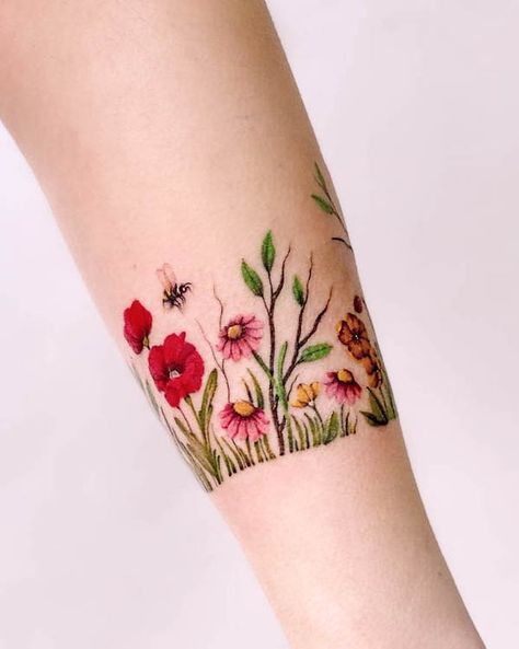 Flower garden bracelet tattoo by @maiko.only Birth Flower Arm Band Tattoo, Tattoo Flower Bracelet Wrist, Water Bracelet Tattoo, Garden Lover Tattoo, Dainty Wrist Bracelet Tattoos For Women, Womens Wrist Tattoos Ideas Beautiful, Wildflower Garden Tattoo, Wildflower Arm Band Tattoo, Bracelet Tattoo Flower