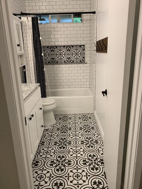 Black and white bathroom with subway tile and vintage flooring Bathroom Black Grout White Tiles, Tile Floor Bathroom Farmhouse, Bathroom Remodel White Subway Tile, Black And White Bathroom Ideas Small, Bathroom With Black And White Floor, Black And White Bathroom Flooring, Guest Bathroom Ideas With Tub, Black And White Bathroom Tile Floor, Shower And Toilet Room Small