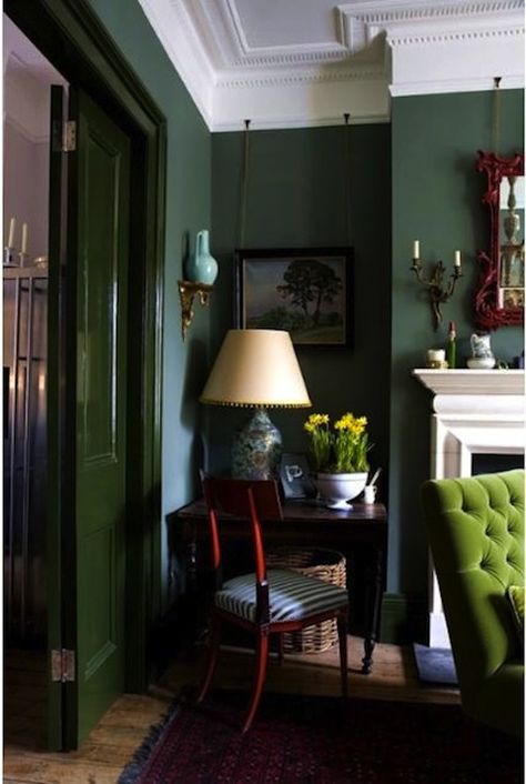 dark green walls with lime green tufted chair & great fireplace. I just don't like that the doors are painted a totally different green; it's too much! House Paints, Green Monochromatic, Green Walls Living Room, Living Colors, Dark Green Walls, Future Room, Green Walls, Dark Walls, Dark Interiors