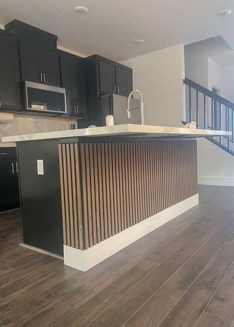 Panels On Kitchen Island, Wood Slats On Kitchen Island, Wooden Slat Kitchen Island, Two Tone Kitchen Cabinets Black And Wood, Island Wrapped In Wood, White Wood And Black Kitchen, Side Cabinet Ideas Kitchen, Reeded Kitchen Island, Island Wood Paneling