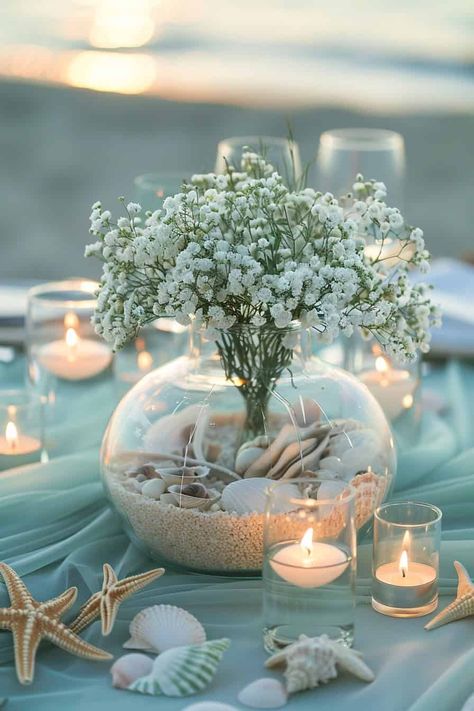 14 Enchanting Baby's Breath Centerpieces For Every Occasion • Beach Centerpieces Diy Party Ideas, Ocean Baby Shower Centerpieces, Beach Wedding Ideas Decorations, Roses In Mason Jars, Baby Breath Centerpiece, Ocean Centerpieces, Baby's Breath Centerpieces, Sand Centerpieces, Beachy Centerpieces