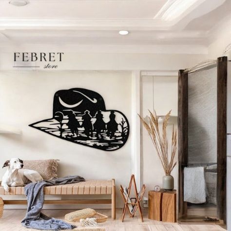 Capture the spirit of the Wild West with our Cowboy Hat Silhouette Metal Wall Art. This beautifully crafted piece showcases a detailed silhouette of a cowboy hat, complete with a Western scene featuring cowboys riding through the landscape. Perfect for adding a touch of rustic charm to your home, this wall art is ideal for living rooms, bedrooms, ranches, or any space that could use a bit of Western flair. Made from high-quality black metal, this wall hanging is both durable and lightweight, making it easy to install and long-lasting. The intricate design not only captures the essence of Western life but also serves as a bold statement piece for your decor. Whether you're a fan of Western movies, a ranch owner, or simply someone who loves unique and artistic home decor, this Cowboy Hat Sil Cowboy Hat Silhouette, Hat Silhouette, Cowboy Hut, Ranch Decor, Western Life, Artistic Home, The Wild West, Western Movies, Cowboy Hat