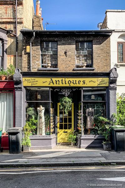 Old Downtown Storefronts, English Store Fronts, Antiques Shop Aesthetic, London Store Fronts, Local Shop Aesthetic, Crystal Shop Exterior, Old Shop Fronts, Storefronts Aesthetic, Pretty Shop Fronts