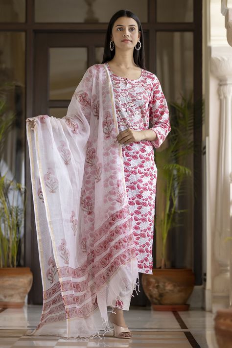 Make a lasting impression with this pink handblock printed cotton suit set. Crafted in a breathable fabric, the kurta features zari and mirror embroidery work on front pannel and three-quarter sleeves. It is paired with parallel pants and a matching floral Kota Doria dupatta with floral motifs on it. Style it with traditional jewellery to complete the look. Block Print Kurti Designs, Wedding Outfits Indian, Hand Block Printed Suits, Printed Kurti Designs, Block Printed Suits, Kurta Pant Set, Designer Kurti Patterns, Stylish Suit, Indian Bridal Dress