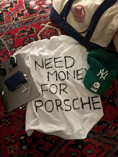 need money for porsche white t-shirt forest green baseball cap ny yankees blue Louis Vuitton wallet trader joes bag apple MacBook earbuds rug aesthetic Couture, Need Money For Porsche, Marca Personal, Need Money, Old Money, Graphic Shirts, Fitness Inspo, Mood Pics, No. 2