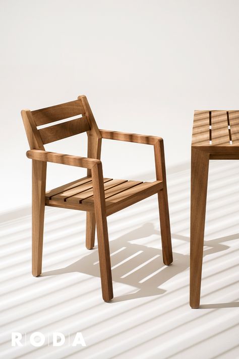 ZANIA is a collection of chairs and tables for outdoor use with a contemporary design that integrates naturally into contract spaces, such as Hotels or Restaurants, and in the most diverse contexts thanks to its small size and great functionality. Composed of a coffee table and a stackable chair with armrests, ZANIA is made of FSC certified Iroko wood, a warm-coloured, durable essence with extreme resistance to wet conditions. #rodadesign #beoutdoor #italianoutdoorlifestyle #design #outdoor Outdoor Wooden Table And Chairs, Wooden Chairs Outdoor, Wood Chairs Design, Small Chair Design, Outdoor Wood Chairs, Outdoor Chair Design, Wooden Outdoor Chairs, Outdoor Reading Chair, Chair For Cafe