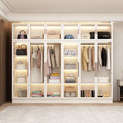 This modern 118-inch wardrobe is a versatile addition to the bedroom, combining storage and fashion. This piece comes with a clear tempered glass door and LED to help you easily prepare for your new day. Made of a metal frame and engineered wood, it features a hinged door mechanism, multiple shelves, and 2 external clothing poles for hanging clothes. Best of all, it comes with a wall anchor to provide extra security in busy homes. | Ivy Bronx Pritt 94.5" Armoire White 74.8 x 94.5 x 19.2 in | C11 Storage For Small Closets Bedrooms, Built In Storage For Small Spaces, Bedroom Storage Cabinet Ideas, Amoire Ideas Bedrooms, Closet Cabinet Ideas, Wall Closet Ideas Bedroom, White Bedroom Furniture Decor, Clear Wardrobe, Library Bedroom Ideas