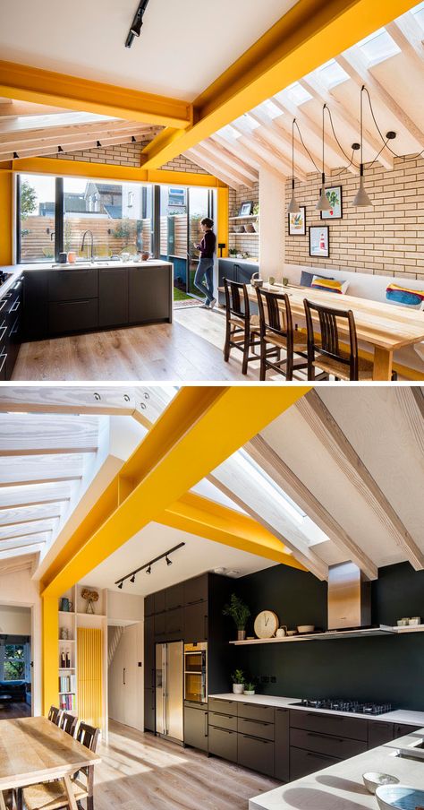 Inside this brick extension by Woodrow Architects, large yellow steel beams provide support, while unconnected rafters sail over with steel plate apex connections allowing the design to do away with any ridge beam.# #YellowBeams #BlackKitchen #BrickExtension  Visit Woodrow Architect's website here > https://www.wdrw.co.uk Dark Wood House, London Terrace House, Brick Extension, Extension Designs, Wood Interior Design, Rear Extension, House Extension Design, Steel Beams, Wood House