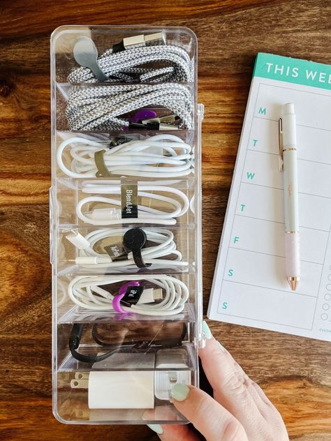 Are your charging cables and cords a tangled mess? Steal these easy ideas for organizing your cord clutter. Charger Cable Organizer Diy, Organisation, Drawer Cable Organization, Organizing Cables And Cords, Extra Cord Storage, Organizing Electronics Storage Solutions, Organizing Electronics Cords, Organize Electronic Cords, How To Organize Chargers Cords