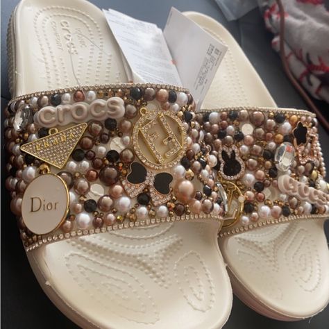 These Are Customized Croc Slides. The Shoe Is A Off-White, Vanilla Color With Brown, Gold, Black And White Decor. Size M4/W6. Never Worn Before, Still Got Tags. Cute Crocs Shoes, Croc Slides, Customized Crocs, Bedazzled Stuff, Pearl Sneakers, Bling Crocs, Crocs Outfit, Shoes Customized, Vanilla Color