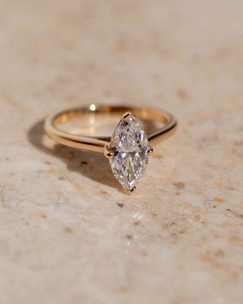 Fun fact - because of their cut, marquise tend to look bigger than their carat weight ✨ This gorgeous solitaire style features a lifted cathedral setting to allow for a straight wedding band to sit flush. Details: - 1.28ct marquise diamond - 14k yellow gold - 1.8mm wide shank #marquiseengagementring #nz #labgrowndiamond #customengagementring #aus Marquise Gold Diamond Ring, Vintage Gold Marquise Engagement Ring, Gold Marquee Engagement Ring, Marquise Oval Engagement Ring, Solitaire Marquise Engagement Ring, Rings Marquise Cut, Marquise Cut Wedding Rings, Marquise Moissanite Engagement Ring, Yellow Gold Anniversary Rings