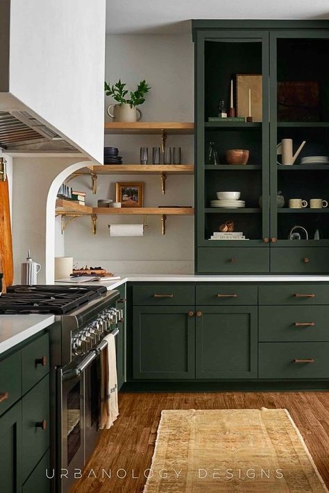 Stunning green kitchen cabinets, open shelving, and organic home decor make this organic modern kitchen an excellent example of a top kitchen trend. This relaxed modern interior design is by Urbanology Designs. ‘Modern serenity, with a hint of handmade and nostalgia.’ This about sums up the interior design style of our Midway Hollow clients, and creating this highly functional yet incredibly tailored kitchen for them was a dream! See the whole home interior design at Urbanology Designs. Dark Cabinets With Butcher Block, Galley Kitchen Two Tone Cabinets, Painted 90s Kitchen Cabinets, Goblin Core Kitchen, Kitchen With Green Cabinets, Urbanology Designs, Dark Green Cabinets, Open Shelving Kitchen Cabinets, Organic Modern Kitchen