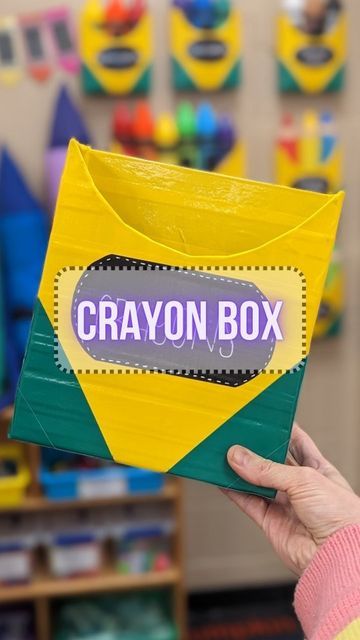 Elementary Art Teacher | Rainbow Outfits on Instagram: "Crayon Box DIY ! Materials: cereal box, yellow/green/black duct tape, pencil, ruler, scissors, paint marker or metallic sharpie (optional, bowl to trace)." Crayon Box Craft, Crayon Decor, Crayon Classroom, Crayon Themed Classroom, August Activities, Crayola Box, Rainbow Outfits, Pool Noodle Wreath, Elementary Art Teacher