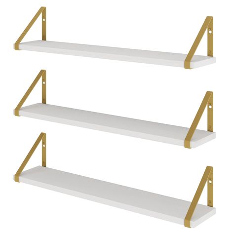 PRICES MAY VARY. Stylish Home Decor: Instead of bulky bookcases, use Ponza white shelves to neatly display and organize your favorite books, decorative frames, indoor plants and more. Keep everything within reach and create a sleek look with these white wall shelves with gold shelf brackets. Superior Quality: Ponza floating book shelves for living room are made of sturdy paulownia wood for long lasting use. 24" x 4.5" Ponza gold wall shelf set of 3 doesn't take up too much space but holds plenty Gold Book Shelf, Office Shelves, Home Office Shelves, Shelves For Living Room, White Wall Shelves, Gold Bedroom Decor, Gold Shelves, Wall Storage Shelves, Shelves For Wall