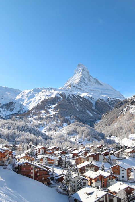 Snow-covered chalets in front of the Matterhorn Ski Resort Switzerland, Winter Switzerland Aesthetic, Zermatt Switzerland Spring, Skiing In Switzerland Swiss Alps, Switzerland Ski Resort, Switzerland In The Winter, Zermatt Aesthetic, Switzerland Winter Aesthetic, Switzerland Aesthetic Winter