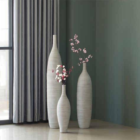 SIZE: Large- 8" Dia x 48" H, Medium- 7.5" Dia x 34" H, Small- 6.5" Dia x 24" H MODERN DESIGN: Adds an elegant touch and a beautiful artistic design to your home MATERIAL: Crafted with a sturdy polyresin material for a long lasting durability FILL THEM:… Tall Vases Decor Living Room, Flower Verse, Long Vases Decor, White Floor Vase, Modern Floor Vase, Living Room Upgrades, Tall Floor Vases, Floor Vases, Sophisticated Decor