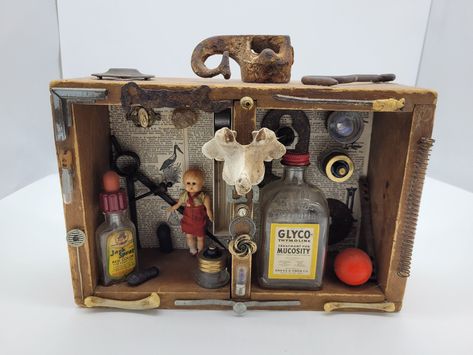 Assemblage art box with antique and vintage items. Found animal bones, antique or vintage medicine bottles, vintage Japanese doll, antique book pages, old wooden box and other epherema. Drawer Ideas, Assemblage Art Mixed Media, Vintage Medicine Bottle, Junk Metal Art, Box Assemblage, Vintage Medicine, Doll Antique, Assemblage Art Dolls, Old Wooden Boxes