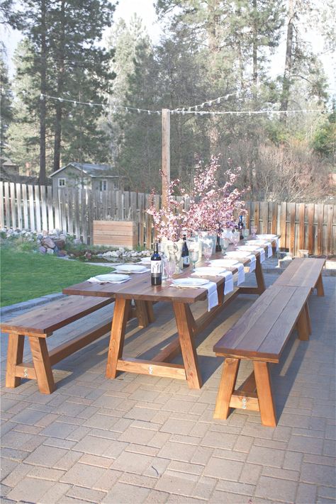 This Pinterest worthy outdoor table was constructed in two days, and took another three days total to sand, stain, and poly. It's the perfect outdoor wooden table. This pine table sits 16 comfortable on the sides, with another 2 possible at each end, for a total of 20 people! Considering all our outdoor gatherings, it's the perfect outdoor accessory. Outdoor Wooden Table, Outdoor Dining Table Diy, Outdoor Farmhouse Table, Outdoor Dinner Table, Outdoor Wood Table, Popular Furniture, Backyard Table, Wooden Garden Table, Table Picnic