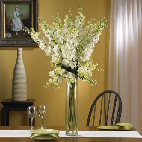 "Spring has definitely sprung… you’ll be thinking that year-round when you gaze upon the whimsical beauty of this lovely Delphinium arrangement. Shop 3ft. Delphinium Arrangement in Glass Vase at Michaels. com. Spring has definitely sprung… you’ll be thinking that year-round when you gaze upon the whimsical beauty of this lovely Delphinium arrangement. Countless stems rise out of the beautiful vase, culminating in an explosion of floral color that looks even better in person than it does in this Delphinium Arrangement, Tabletop Floral Arrangements, Dramatic Table, Delphinium Flower, Tall Floral Arrangements, Delphinium Flowers, Glass Cylinder Vases, Silk Arrangements, Centerpieces Wedding