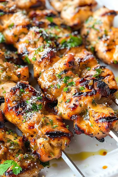 Discover the perfect blend of flavors with these Spicy Parmesan-Garlic Chicken Skewers! Juicy chicken thighs are seasoned, skewered, and grilled to perfection, then brushed with a mouthwatering spicy garlic parmesan butter. Ideal for your next barbecue or family dinner, these skewers offer a delicious twist on a classic favorite. Pin this recipe now and make your next gathering a flavorful feast! Health Grilled Chicken Recipes, Healthy Chicken Grilling Recipes, Garlic Chicken Kabobs On The Grill, Blackstone Chicken Skewers, Bbq Chicken Ideas Grilled, Chicken And Steak Skewers, Barbecue Chicken Skewers, Parmesan Grilled Chicken, Barbecue Recipes Grill Meat