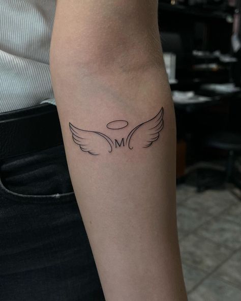 Best 70+ Wing Tattoo Designs Ideas - May 2024 Wings With Letter Tattoo, Forearm Tattoo Women Angel Wings, Angel Wing Initial Tattoo, Tattoo With The Letter A, Angel Tattoo With Initials, Halo And Angel Wings Tattoo, Forarm Tattoos Woman With Meaning, Letter With Angel Wings Tattoo, Tattoo S Letter